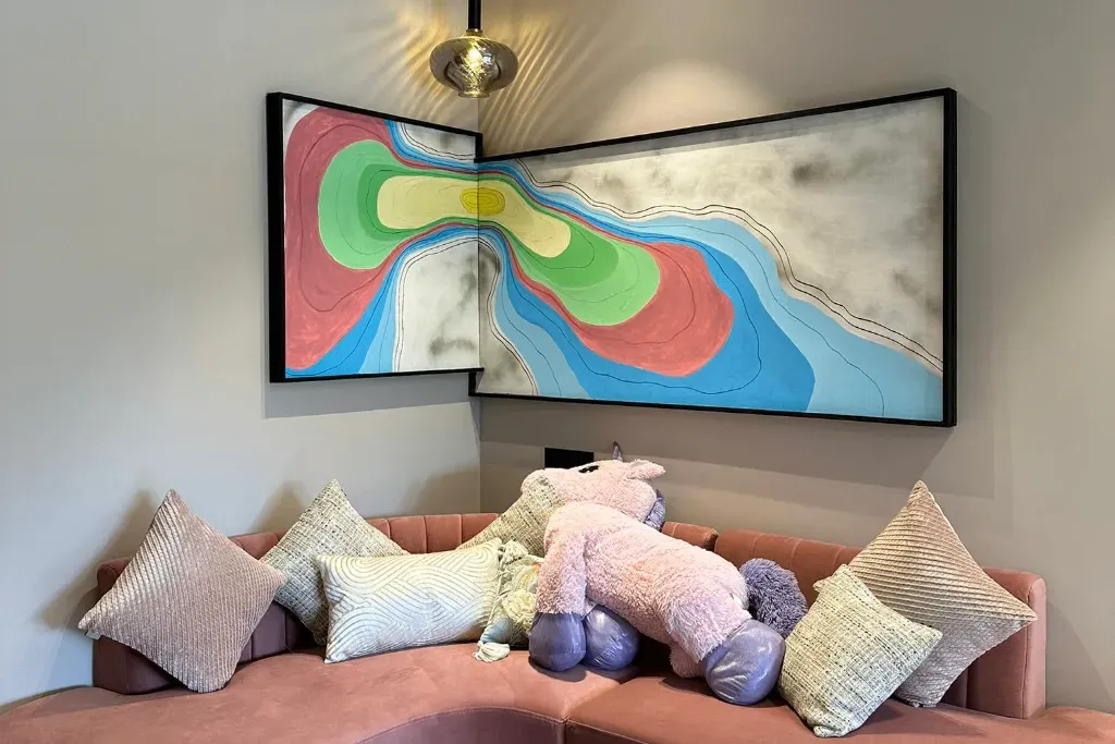 A round live-edge wood wall clock featuring a swirling white and translucent silver epoxy resin river.