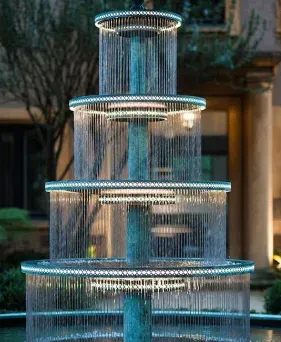 Modern multi-tiered black and white stone outdoor water fountain wall.